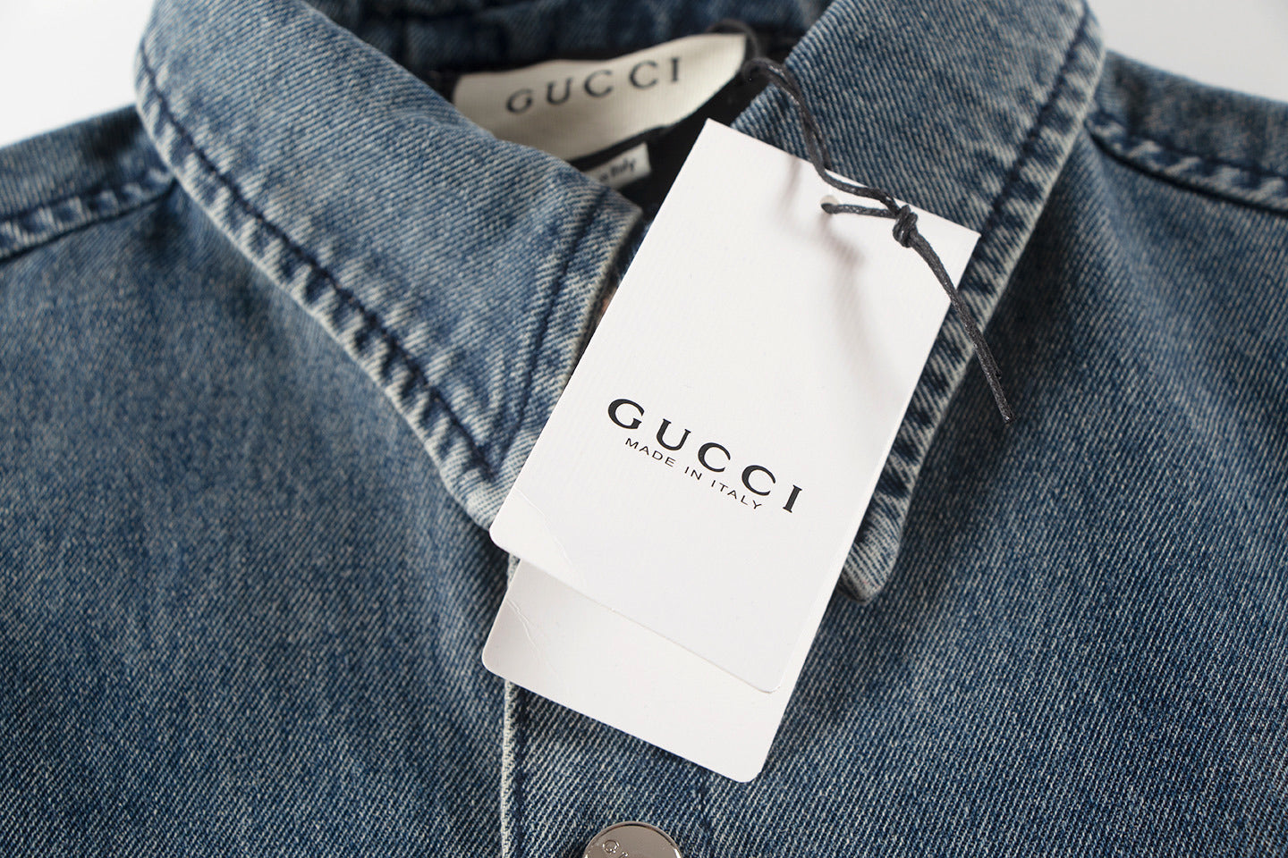 Model wearing the Gucci Denim Bowling Blue Shirt, showcasing its short sleeves and stylish look.