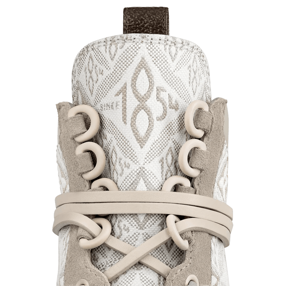 Close-up of Louis Vuitton Laureate Platform Desert Boots featuring a treaded platform outsole, long leather laces, and a Monogram canvas back loop.