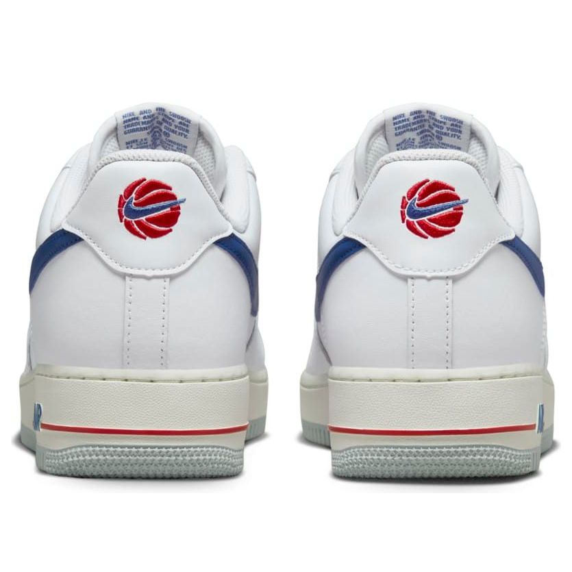 Styled shot of Nike Air Force 1 '07 'USA - White Game Royal on ground, perfect for showcasing streetwear fashion.