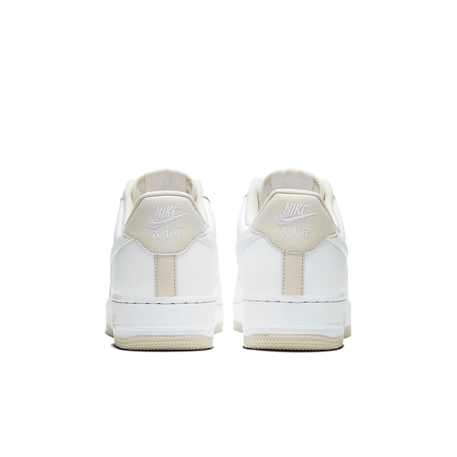 Lifestyle shot of Nike Air Force 1 Low 'White Light Bone' worn in an urban setting, emphasizing its stylish appeal and classic silhouette.