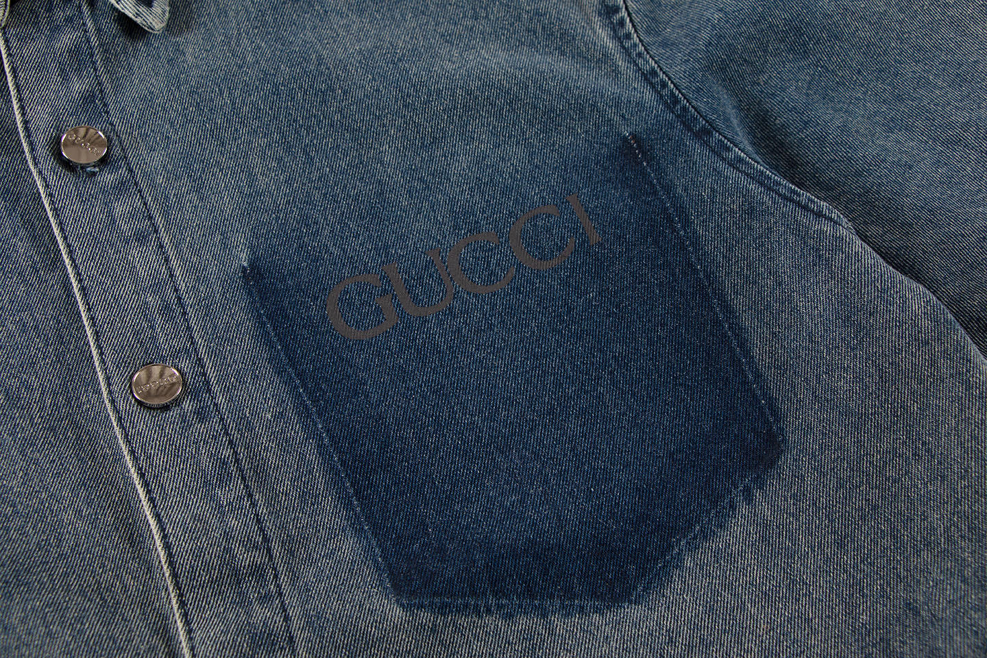 Flat lay of the Gucci Denim Bowling Blue Shirt highlighting its unique denim-style cotton fabric.
