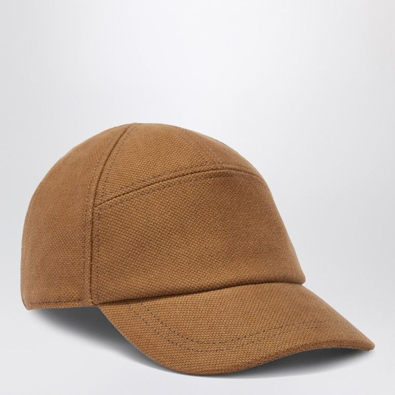 Brown textured fabric baseball cap on a plain background