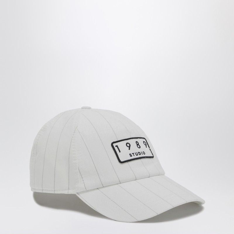 White pinstripe baseball cap with '1989 Studio' embroidered patch on front