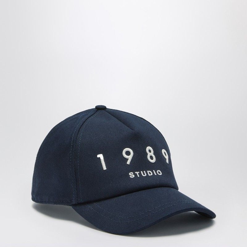 Navy blue baseball cap with white embroidered 1989 Studio text on the front