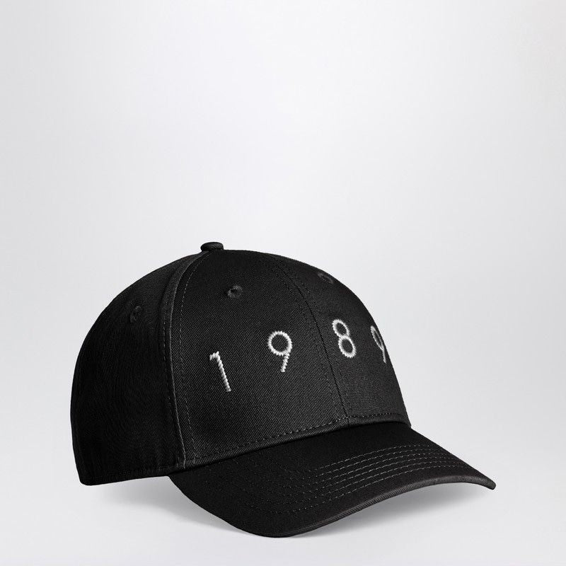 Black baseball cap with white 1989 embroidery, fashion accessory on plain background
