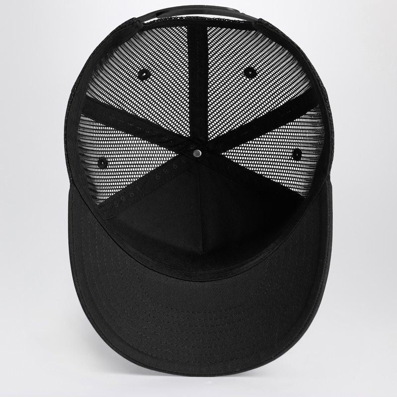 Black mesh trucker cap with snapback closure, inside view, fashion accessory