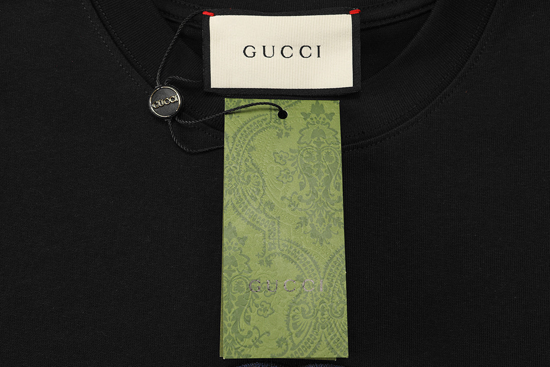 Model wearing the Gucci T-Shirt Without Collar 'Black' styled with jeans for a casual yet sophisticated look.