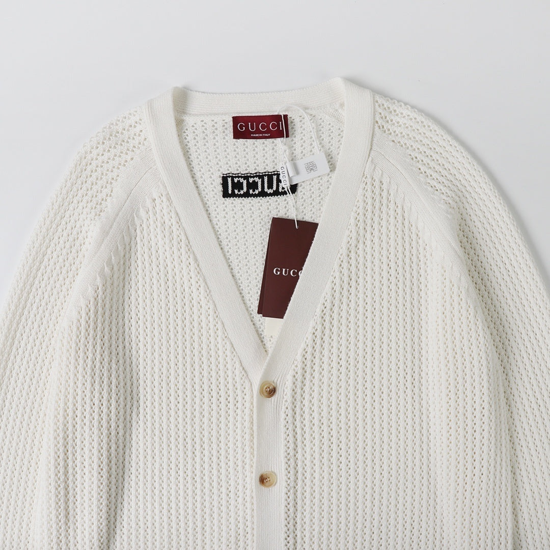 Detailed view of Gucci Sylvie Web-stripe cardigan showcasing its elegant white cotton fabric and signature Web stripe design.