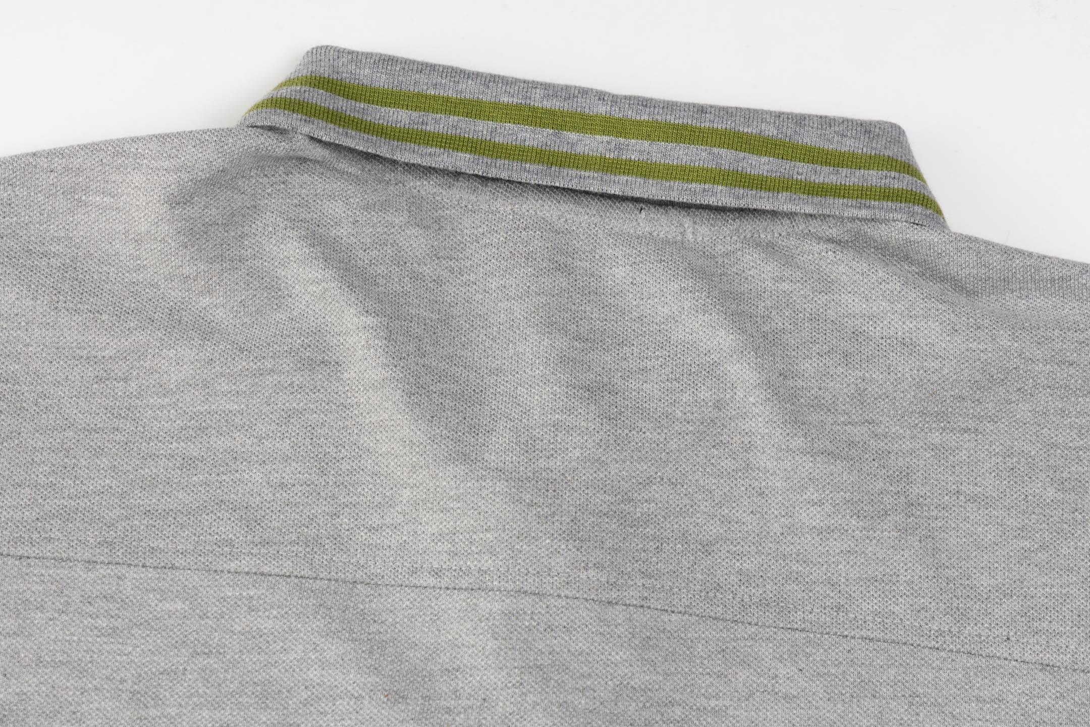 Gucci T-shirt with a collar displayed flat, emphasizing the understated elegance and subtle branding of this classic tee.