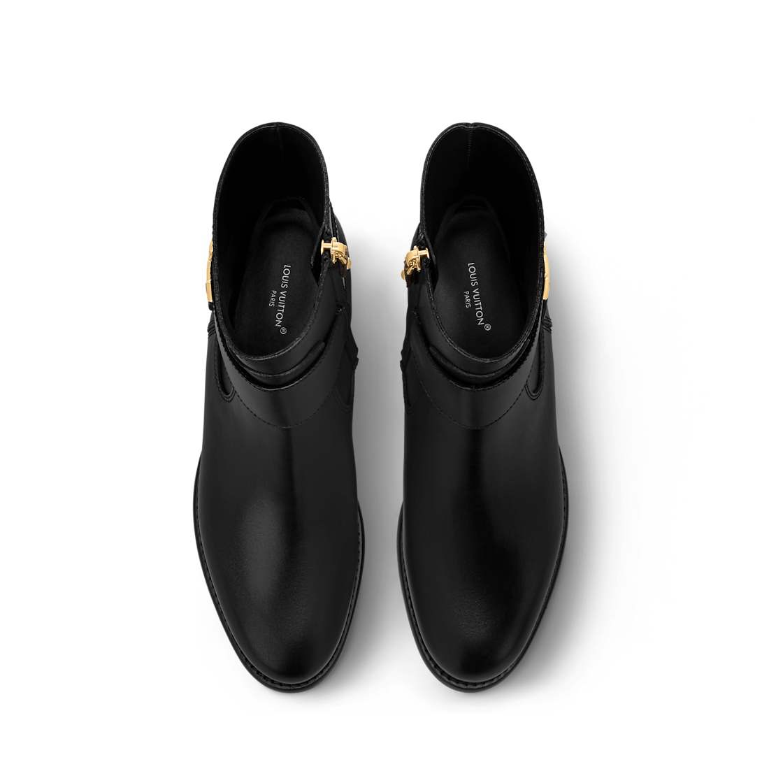 Stylish display of the Louis Vuitton Midtown Flat Ankle Boot on a neutral background, highlighting its elegant design.