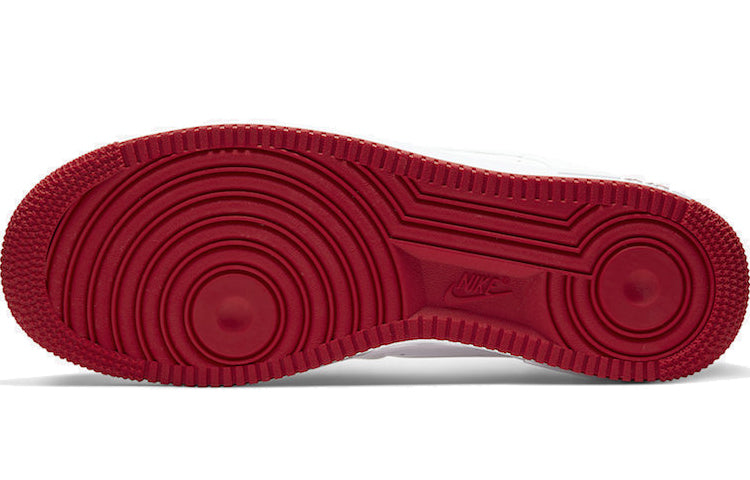 Nike Air Force 1 Low 'University Red' on a textured surface showing the durable rubber outsole and traction details.