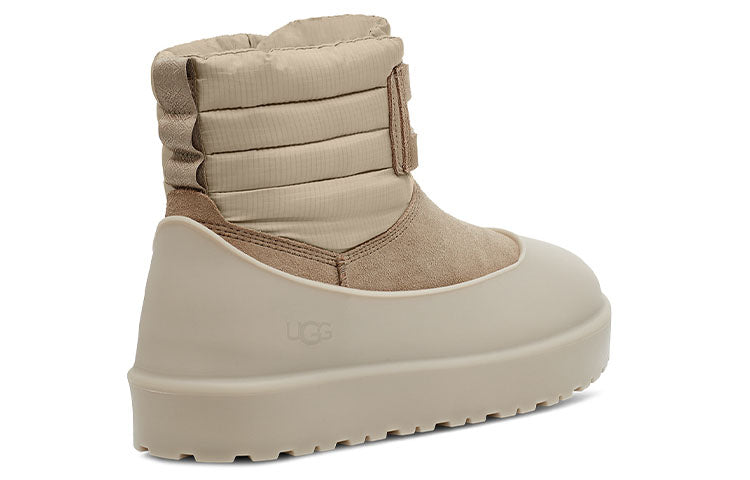 Lifestyle image of UGG Classic Mini Lace-Up Weather Boot 'Dune' worn in an outdoor winter setting, perfect for cold weather.