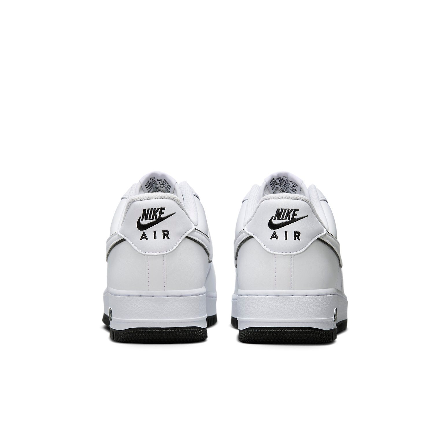 Nike Air Force 1 Low 'White Black' photographed from above, showing the clean white leather design and black Swoosh outline.