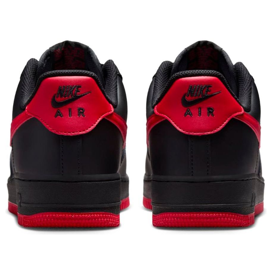 Nike Air Force 1 Low 'Vamps' stylish black suede sneaker with deep red accents on the sole and side Swoosh, showcasing its iconic basketball silhouette.