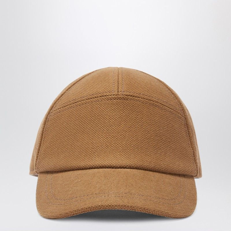 Front view of a brown canvas baseball cap on a plain white background