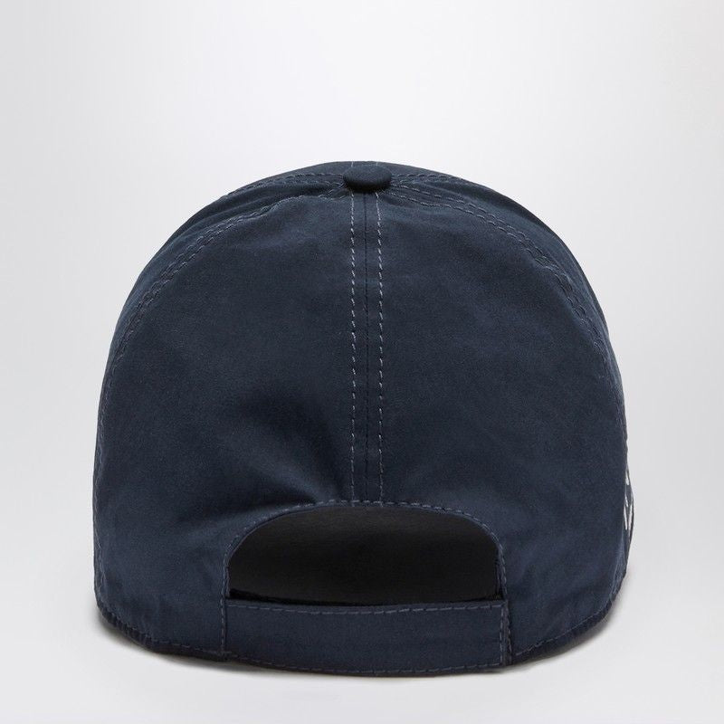 Back view of a navy blue baseball cap with adjustable strap and white stitching