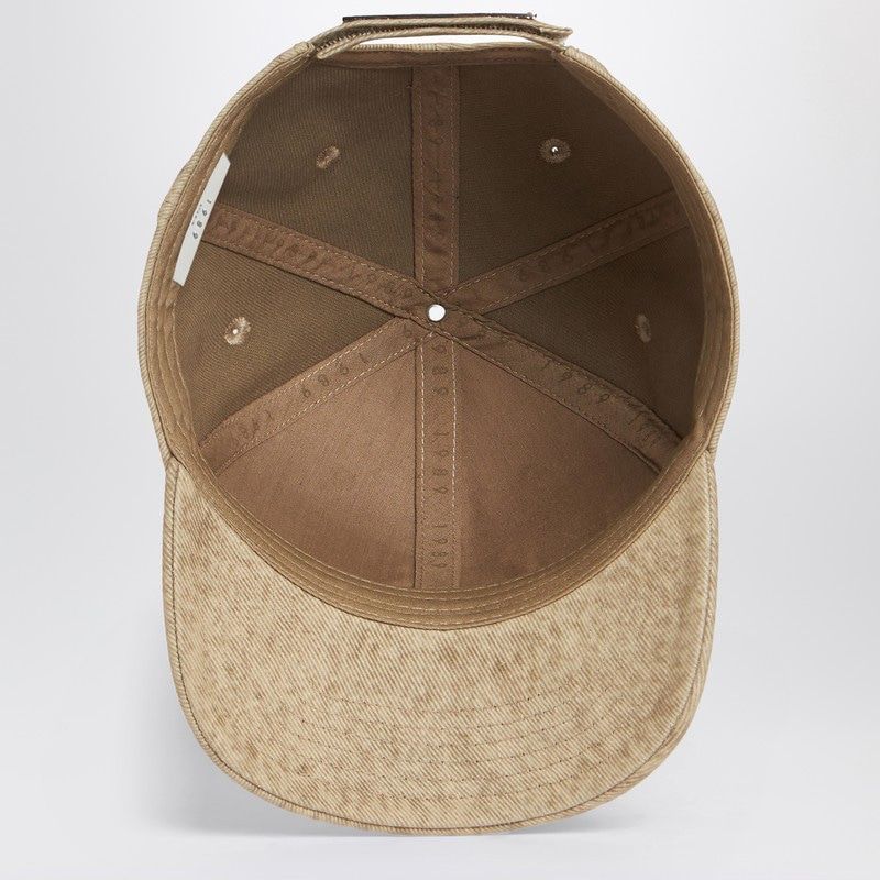 Inside view of a brown cotton baseball cap with adjustable strap and six-panel design