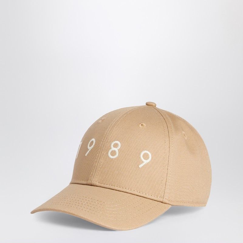 Beige baseball cap with white embroidered numbers 1989 on the front, minimalist style