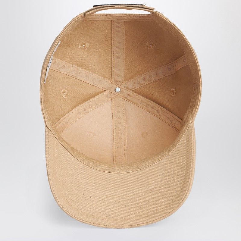 Interior view of a beige fashion cap with structured panels and curved brim