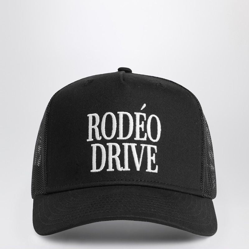 Black mesh trucker hat with white Rodéo Drive embroidered text, front view