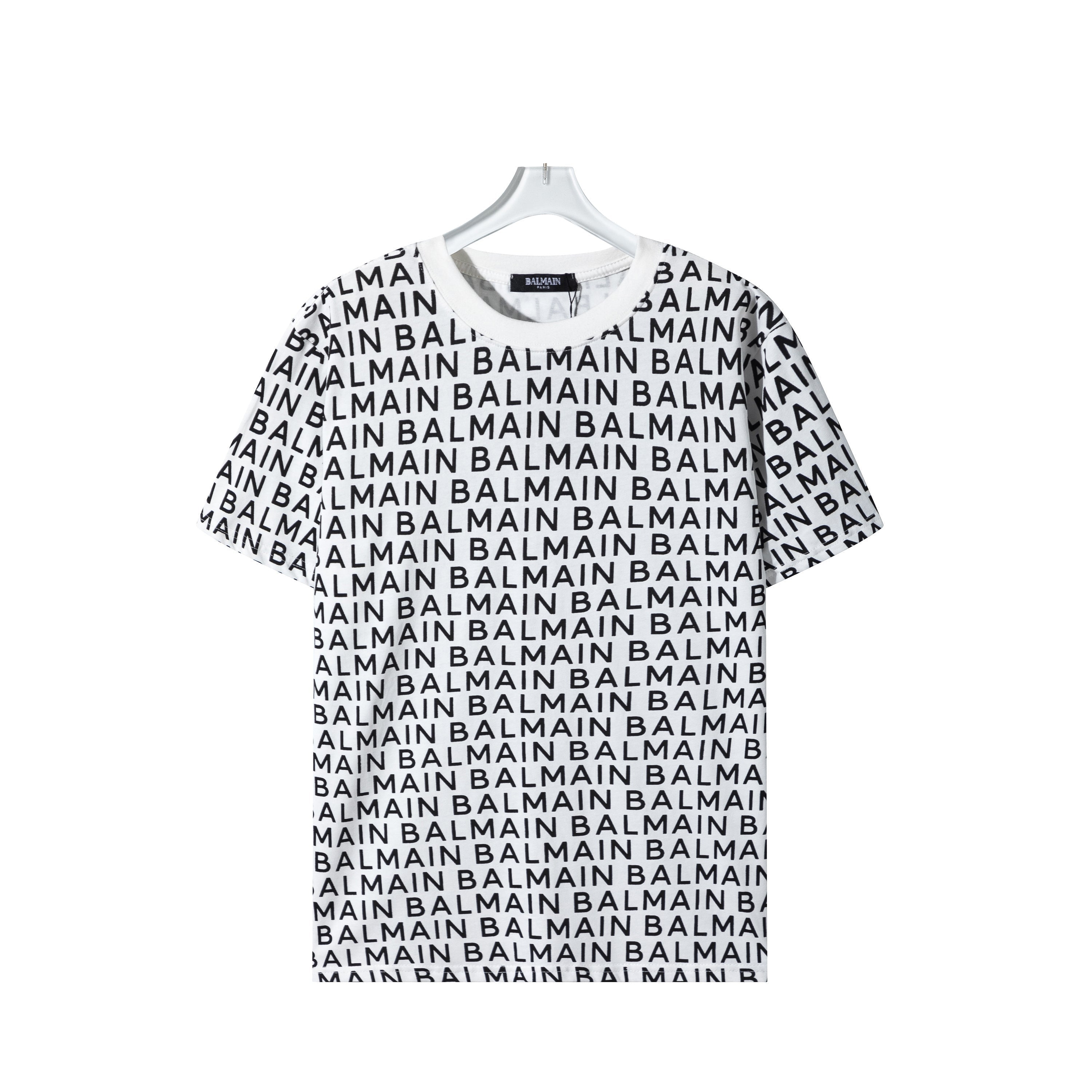 White t-shirt with black 'Balmain' logo pattern on a hanger