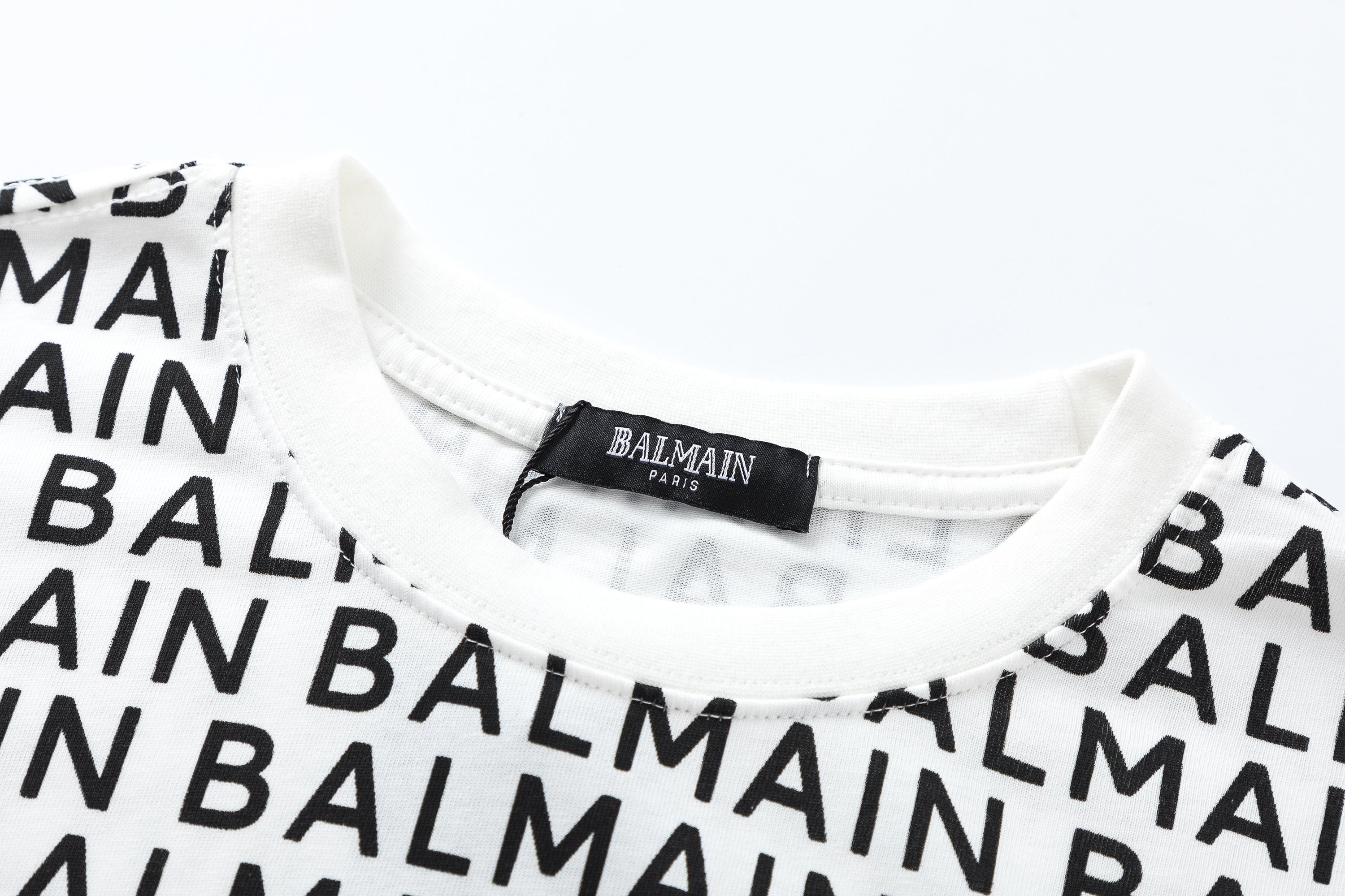 Stylish BALMAIN Logo Print T-shirt showcasing bold logo design, made of high-quality cotton, perfect for casual wear and streetwear looks.