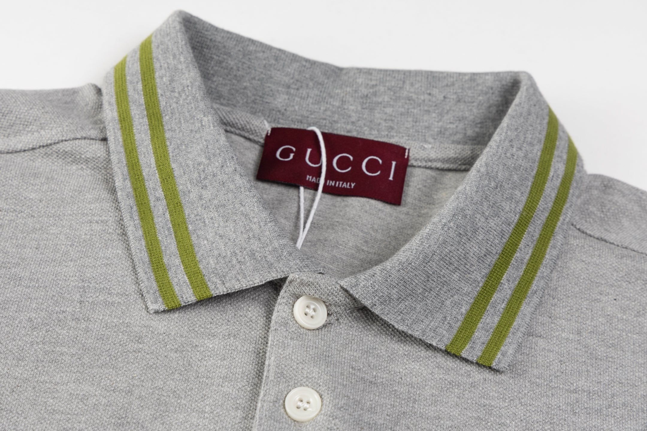 Model wearing the Gucci T-shirt with a collar, demonstrating its versatile style paired with jeans for a casual look.