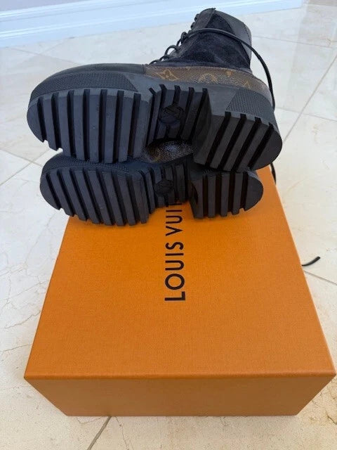Close-up of Louis Vuitton Laureate Platform Desert Boots emphasizing the treaded platform outsole and long leather laces.