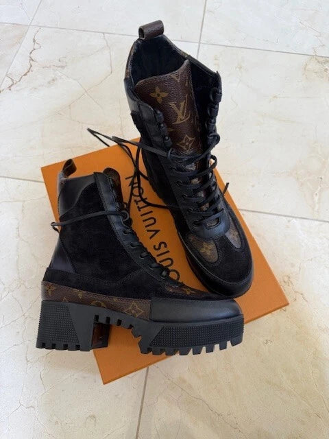 Angled view of Louis Vuitton Laureate Platform Desert Boots highlighting treaded outsole and Monogram canvas back loop.